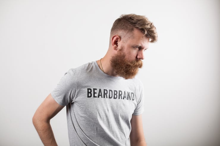 Man with long beard wearing a Beardbrand t-shirt